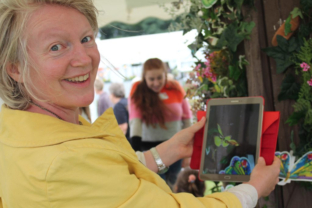Dr Jessica Symons demonstrating augmented reality technology at an exhibition